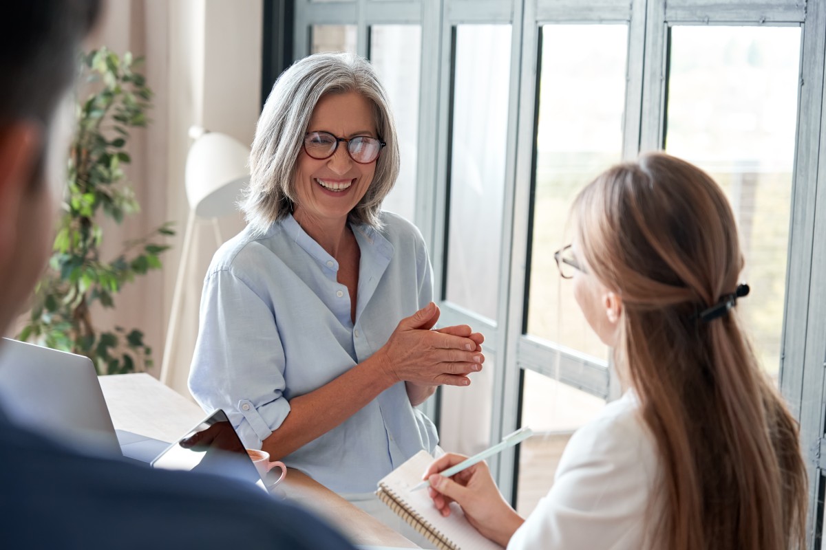 older woman mentors younger woman 382934760