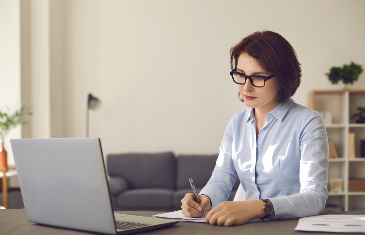 female financial advisor studies at laptop 438751028